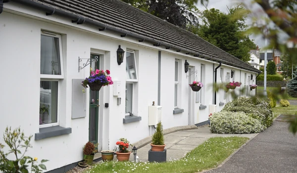 View of a long row of white bungalows at Wesley Court