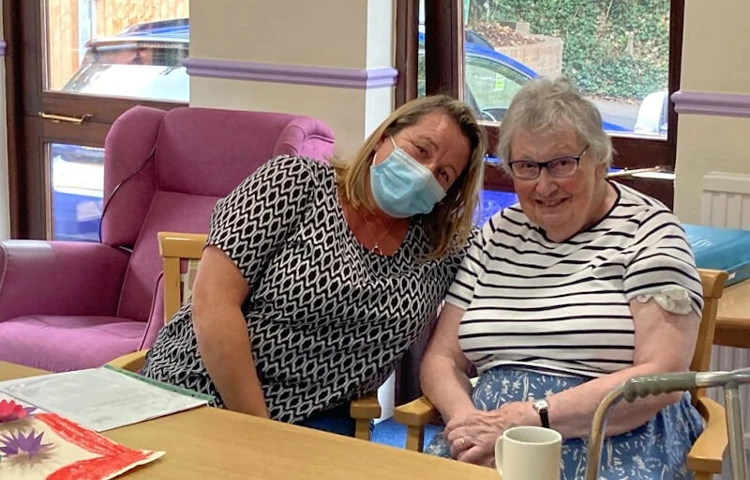 Staff Member And Resident Taking Part In An Activity Together