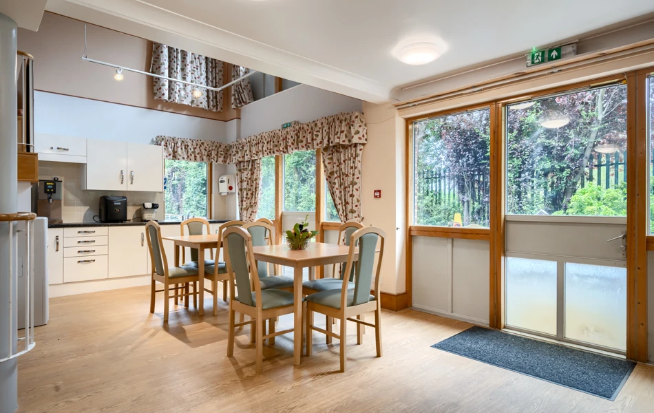 Cafeteria with table and chairs at Abbeyfield House, New Malden