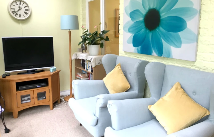 Communal lounge with tv where residents at Abbeyfield House, Sutton can relax