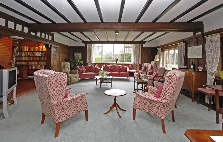 Large living room with beamed ceilings where residents can relax and socialise