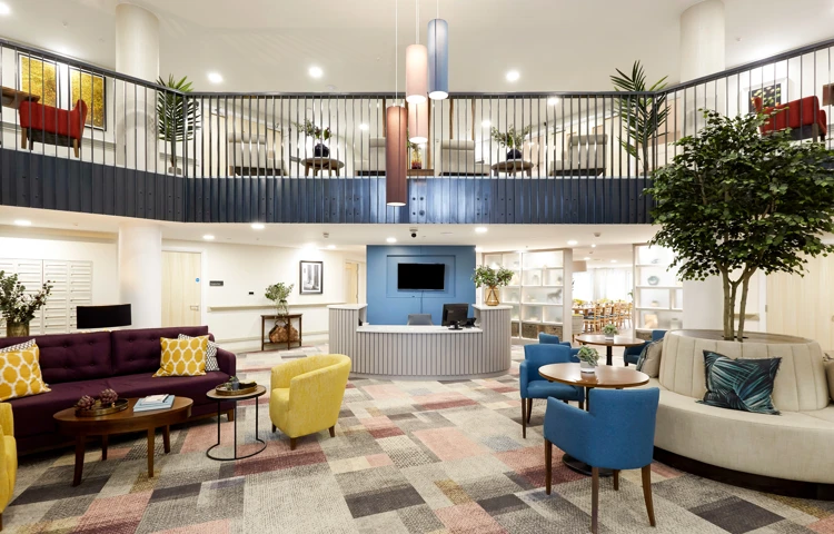 Large, modern reception area at Nonsuch Abbeyfield with sofas, seating areas and reception desk