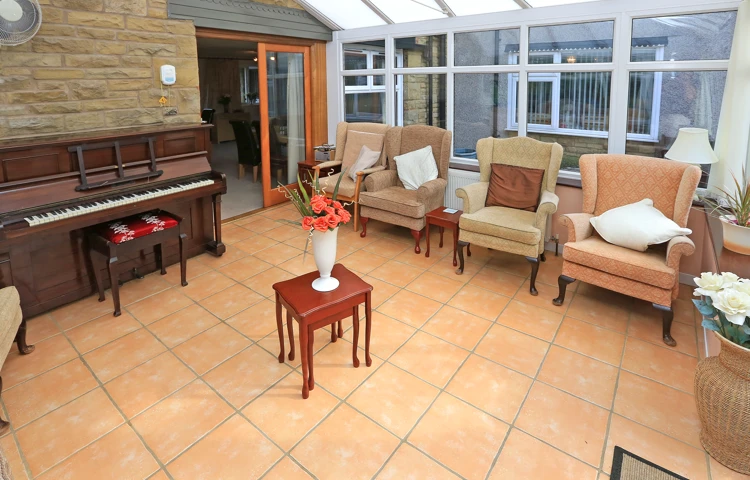 A conservatory with seating and a piano