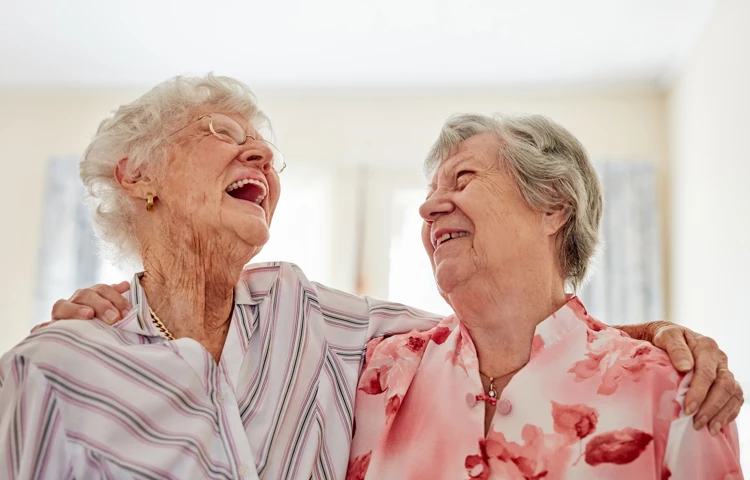 Two ladies laughing together