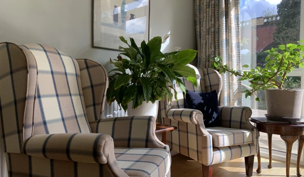 Bright and sunny seating area with armchairs for residents to catch up or relax