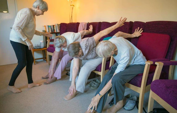 Residents taking part in armchair based exercises at Abbeyfield House