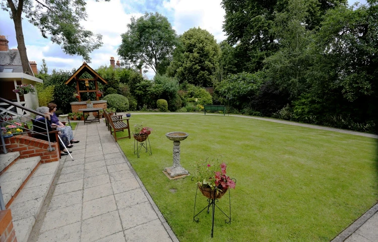 Residents sitting on the bench in the garden enjoying the fresh air