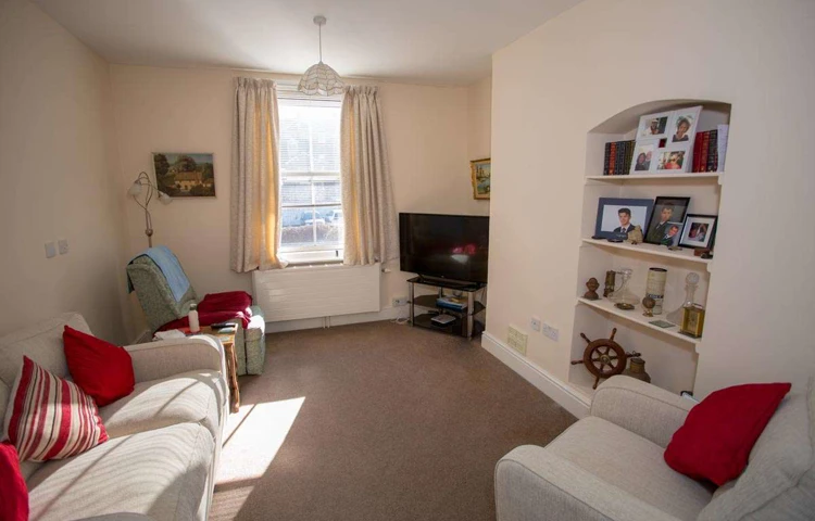 Bright communal lounge where residents can enjoy watching the TV, relaxing or socialising at Abbeyfield House,