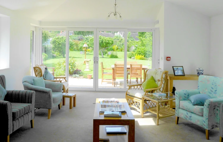 Communal lounge overlooking the lovely garden where residents can enjoy the views and socialise with other residents