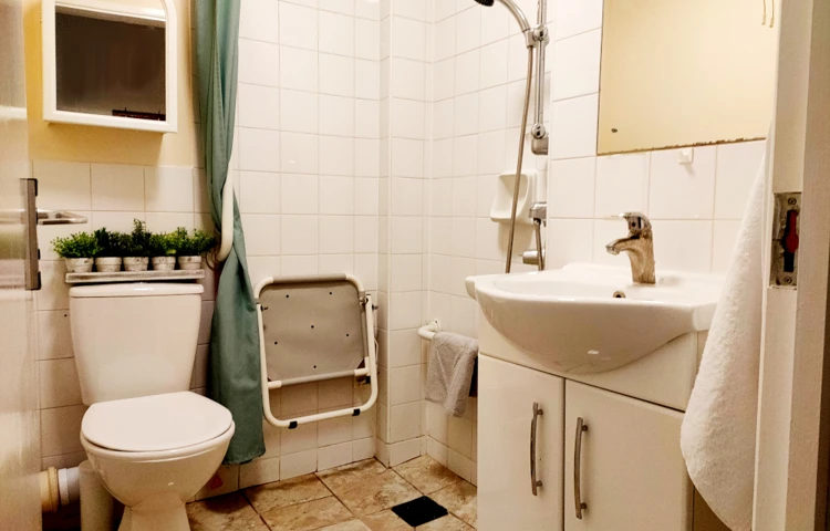 En-suite resident bathroom with wet room