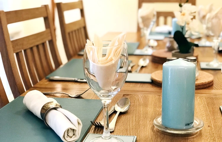 Beautifully set communal dining table where residents come together to share meals
