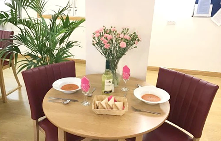Table and chairs with meal on the table at Westbourne House