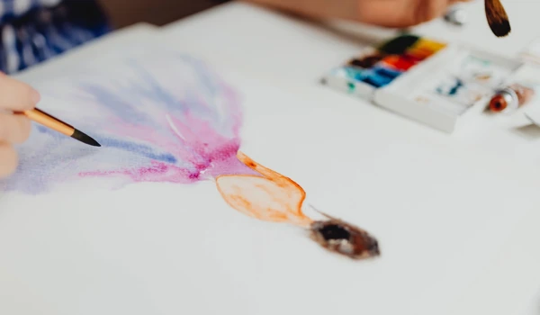 Person Painting A Picture Of Ballerina In Watercolours