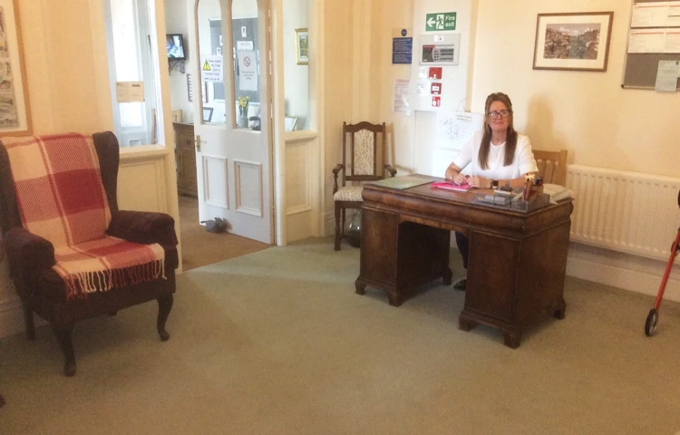 Reception area with a member of staff at a desk