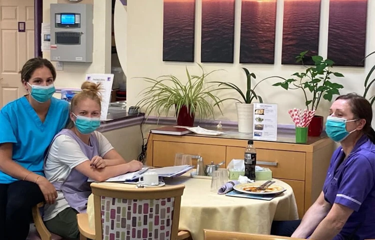 Staff Members Sitting Together At Lunch Time