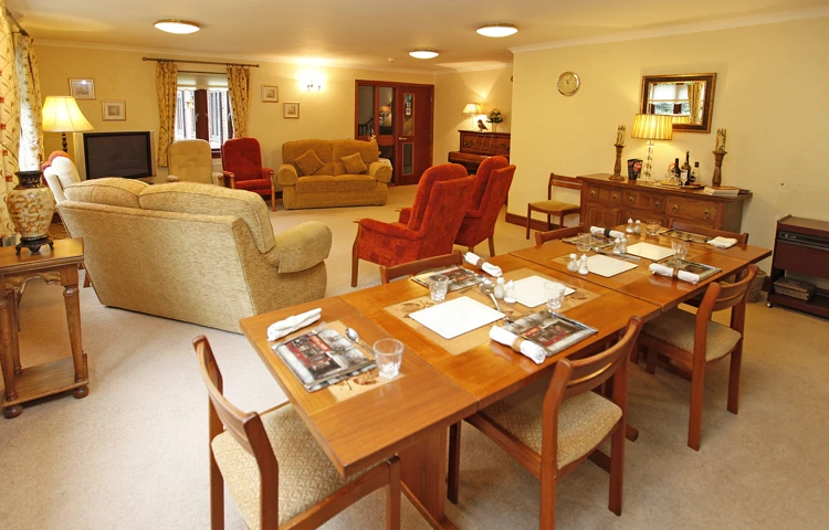 Dining table set for dinner and the lounge area