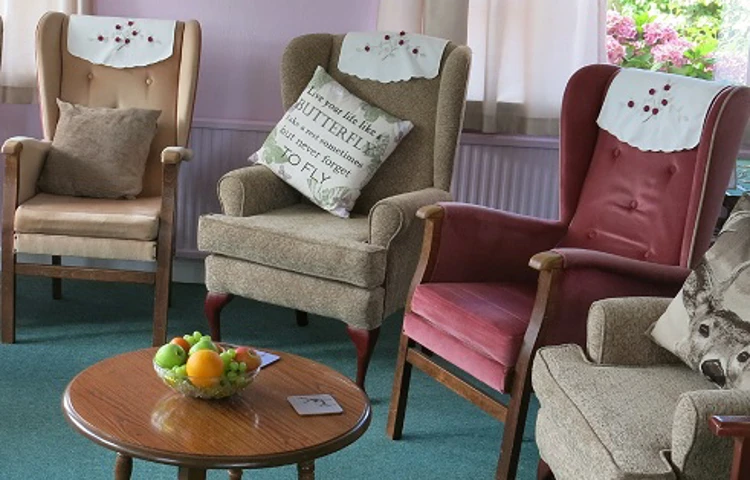 Plenty of comfy chairs and fruit on table in the residents lounge
