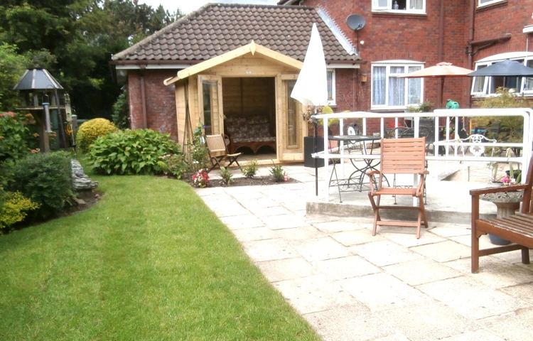 The house garden with seating and a summer house