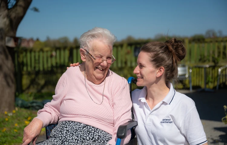 smiling-happy-resident-and-staff-enjoying-the-garden-at-nicholas-house.jpg
