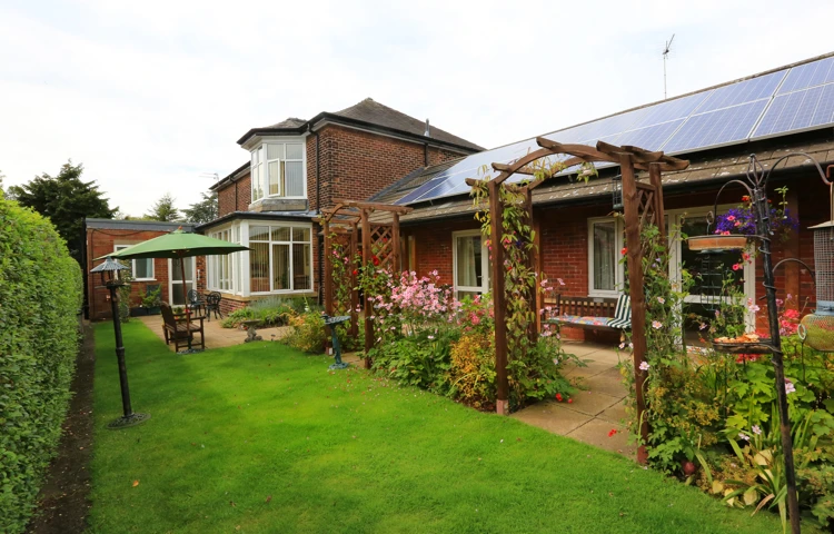 Garden area with plants and flowers and a seating area